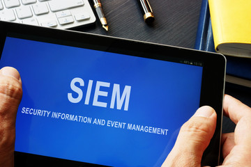 SIEM Security information and event management program in a tablet. - obrazy, fototapety, plakaty