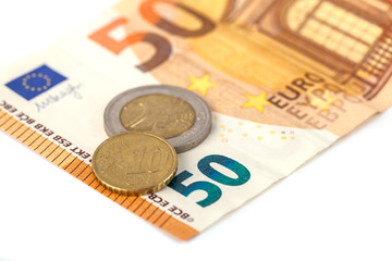 Stack of Euro banknotes and coins isolated. 50 Euro banknot
