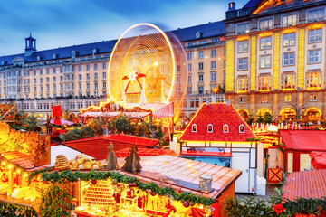 Traditional European Christmas Market in Dresden, Germany, Saxony. View on amusement park - the...