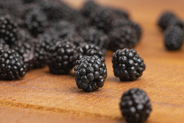 Ripe blackberries on a wooden table. Macro image.
