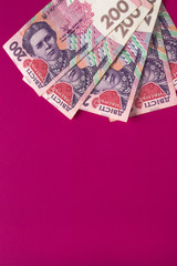 Ukrainian money isolated on pink background. Banknotes of 200 UAH