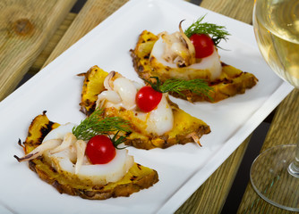 Image of sepia fried on a grill with pineapple, cherry tomatoes and sauce Chile