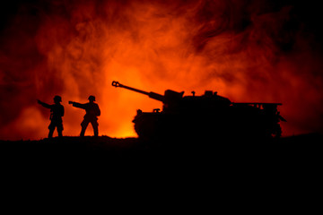 Fototapeta na wymiar War Concept. Military silhouettes fighting scene on war fog sky background, World War German Tanks Silhouettes Below Cloudy Skyline At night. Attack scene. Armored vehicles.