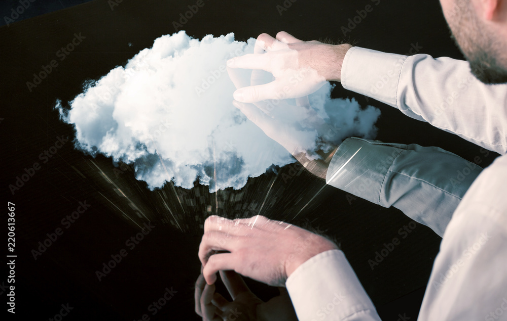 Poster male hands touching interactive table with a white cloud on it