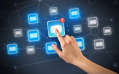 Female hand touching unread mail icon with more envelope icons around it 