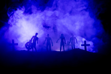 Naklejka premium Scary view of zombies at cemetery dead tree, moon, church and spooky cloudy sky with fog, Horror Halloween concept.