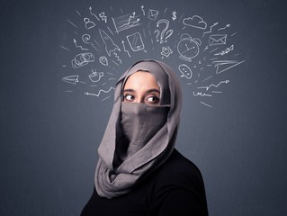 Young muslim woman wearing niqab with mixed white drawings above her head