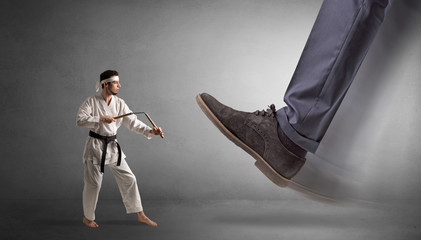 Big foot treading small young karate man