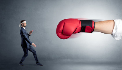 Little man fighting with a giant red boxing glove
