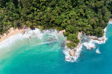 Tropical Sea Aerial view drone shot of amazing beautiful nature background and clear water with wave crashing on rocks coast in phuket Thailand. - obrazy, fototapety, plakaty