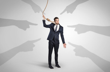 Young businessman trying to suicide with pointing hands concept
