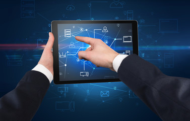 First person view of a hand using tablet with cloud office concept
