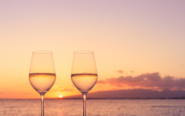 Pair of wine glasses, and romantic sunset view. 