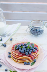 Vintage pancakes outside garden with blueberries