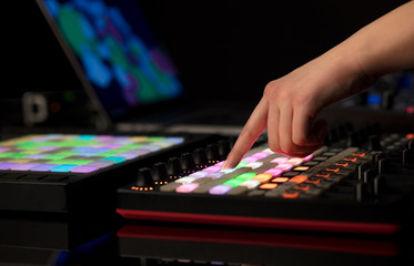 Dj hand remixing music on midi controller
