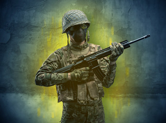 Hazard, menace soldier in a ruined crumbly building with arms on his hand
