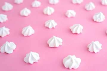 White meringues on pink background, pattern