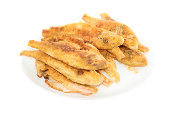 Dish of fried fishes red mullets isolated on white background