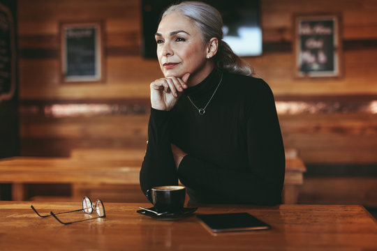 Thoughtful Senior Woman At Coffee Shop