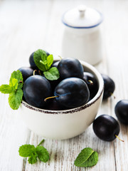 Bowl with fresh plums