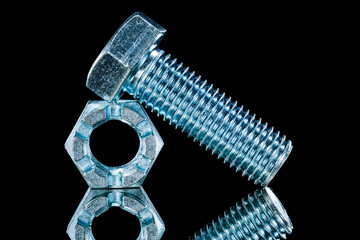 Threaded crown nuts bolts on black background horizontal view