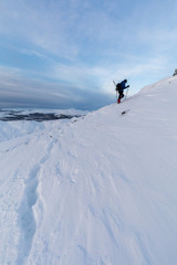 Naklejka na ściany i meble Winter hill walker on the slopes of Ben Ledi, Scotland