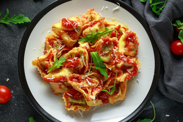 Spinach ricotta Ravioli in tomato sauce with wild rocket and parmesan cheese