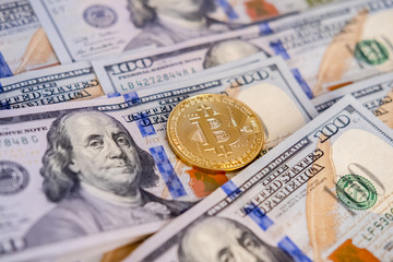 Golden bitcoin coin on us dollars close up. BTC. Bitcoin cash.