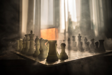chess board game concept of business ideas and competition and strategy ideas concep. Chess figures on a background with window.