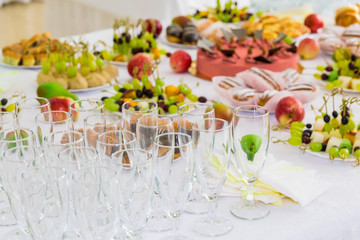 Served tables at the Banquet. Desserts, fruit and pastries on the buffet. Glass. Catering.