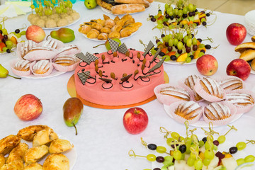 Served tables at the Banquet. Desserts, fruit and pastries on the buffet. Catering.