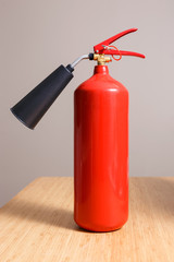 Fototapeta premium Fire extinguisher on the table in empty room