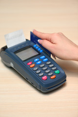 Girl pays purchase through the terminal pos