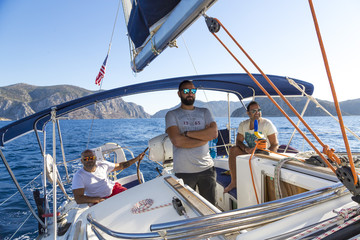 Three men hanging on the boat