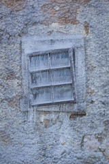 An old broken window in ice