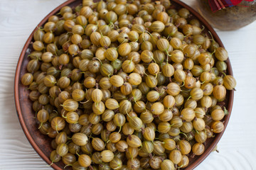 Ripe gooseberry in a plate, place for text, top view, summer harvest of berries