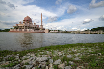 Pink color Putrajaya mosque surrounded by water at Putra Jaya city, the Malaysian Federal Territory administrative city