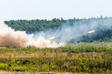 Launching military rockets in the woodlands, war shot defense attack.