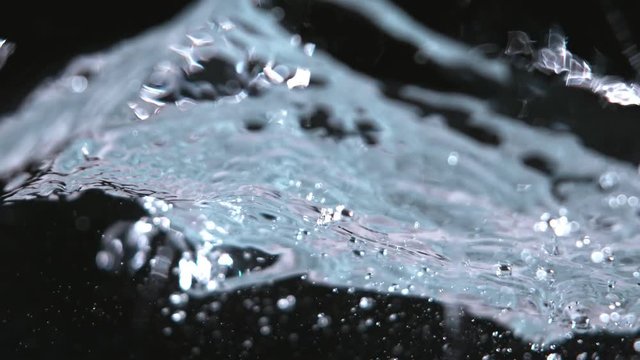 Super slow-motion shot of water wave against black. Shooted with high speed cinema camera at 1000fps.