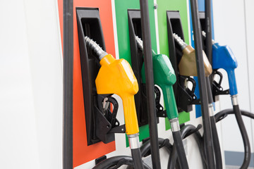 Fuel Pump, Gas Station, Gasoline.Colorful Petrol pump filling nozzles isolated on white background , Gas station in a service in warm sunset.Head fuel vehicle refueling facility in Asia