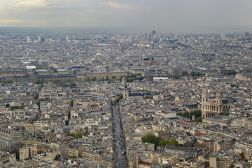 The top view on the city in cloudy, rainy weather. Houses and streets of Paris. France