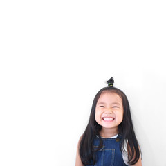 Asian children cute or kid girl and kindergarten student happy smile white teeth and laugh thinking for new idea with wear dungarees jean for fashion at school on white background with space isolated