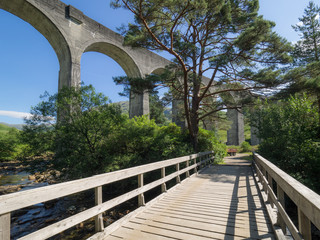 Genfinnan Viaduct seen from below from a small wooden bridge