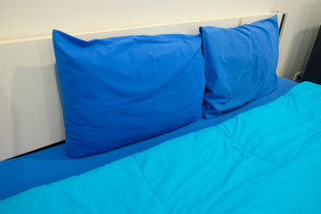 Blue pillows and blue bed sheets