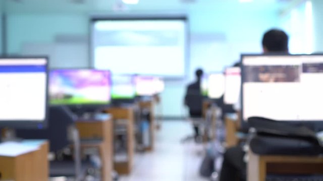Blurred students learning technology for computer training in computer classroom at university. E-leaning for network communication, education online concept.
