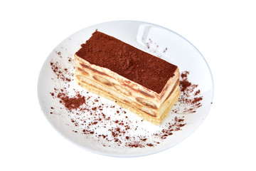 Tiramisu cake/ dessert with cacao on a porcelain plate on the white background