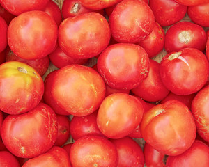 Fototapeta na wymiar organic tomatoes top view, natural red background