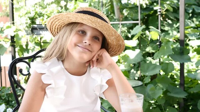 Portrait of cute girl in a straw hat enjoying sun in garden.Pretten girl smiling and lauging at camera. 4k