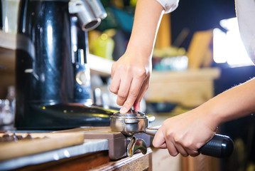 Barista make coffee espresso shot by streaming machine in coffee cafeteria bar. Brewing Process concept. coffee blending process. image for background, wallpaper,decoration and copy space.