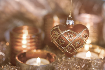Elegant christmas heart ornament and candles copper colored, perfect for christmas cards and...